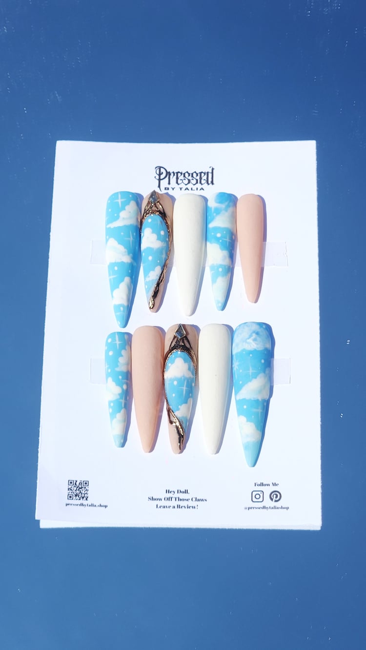 Extra extra long stiletto shaped handmade press-on nails with sky blue and cloud designs, customizable with white and nude acrylic nails, gold chrome baroque style accent press-on nails