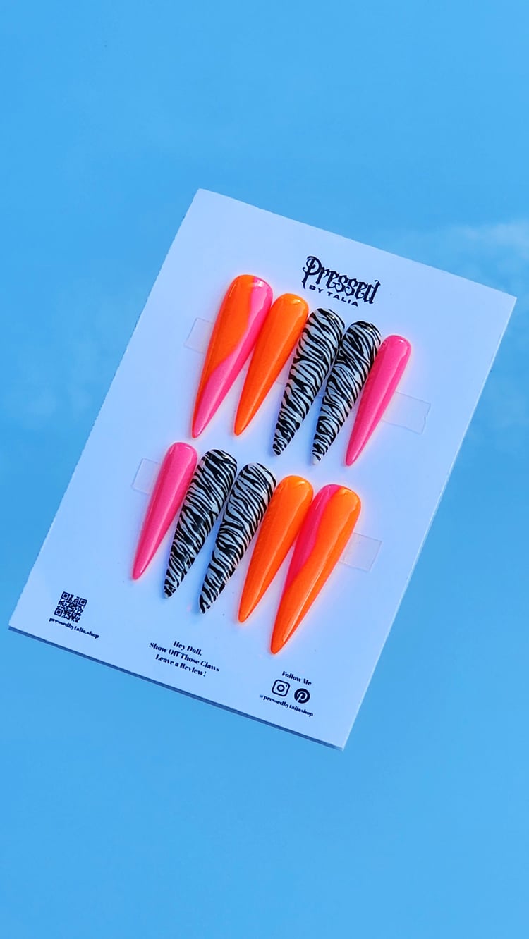 Extra extra long stiletto shaped press-on nails with hot pink and neon orange ombre and handmade zebra printed nails