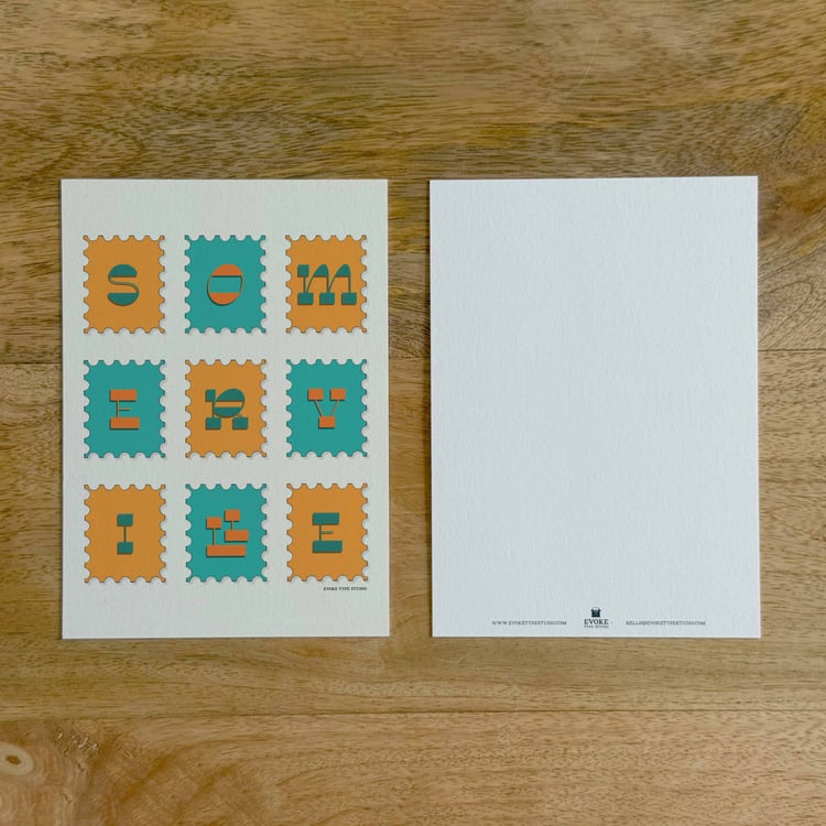 Two sides of a notecard, with postage stamp artwork on the front and a mostly blank back with company contact information at the bottom of the notecard.