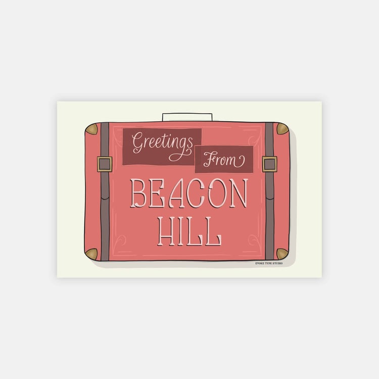 A postcard of a vintage style suitcase with the words “Greetings from Beacon Hill” drawn in unique lettering styles. Artwork has a pink, burgundy and gray color scheme