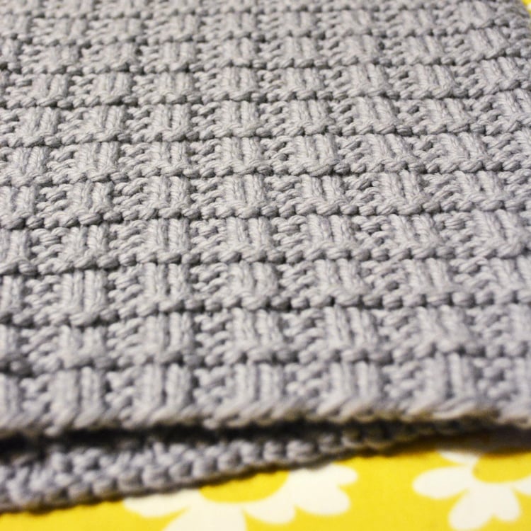Close-up of a bulky-knit scarf with a waffle weave texture.