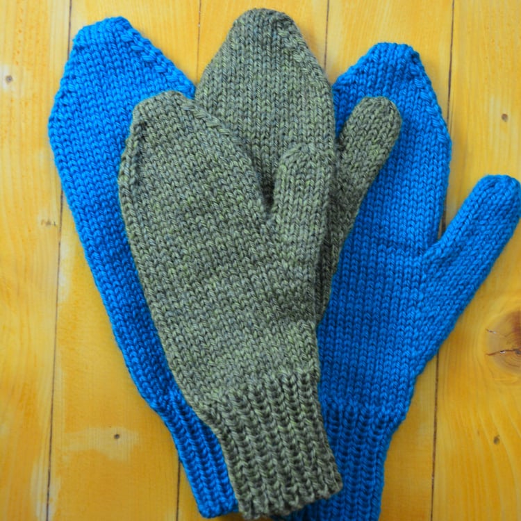 Two pairs bulky-weight mittens with new thumbs and yarn.
