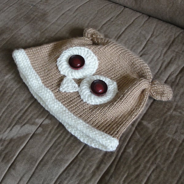 Cute and quirky knitted owl hat for kids with crocheted features and button eyes. Garter stitch brim. Two colours.