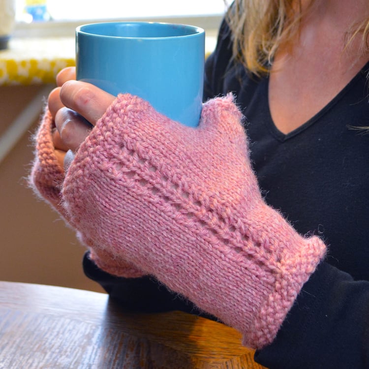 Close-up of the fingerless mitten backs on hands showing the seed stitch border on the top, thumb edge, and the pretty twin rows of eyelets creating the lace "vine" up the back.