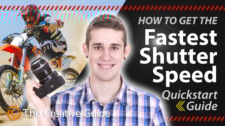 A young man holding a camera and ordinary kit lens smiles after he has captured a fast moving motor bike as if it was frozen - The Creative Guide