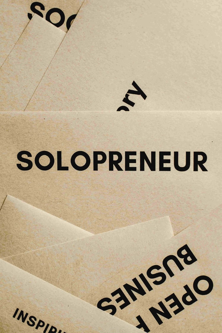 beige papers with the words solopreneur and business opportunity on it
