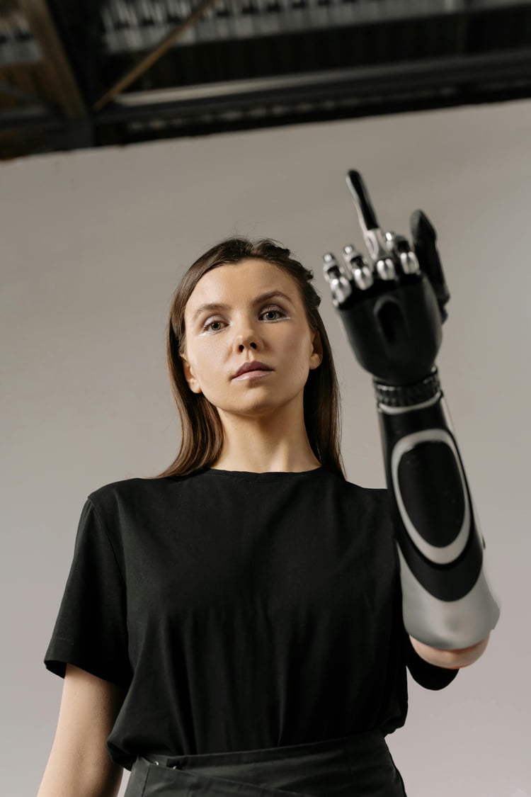 a young white woman with a prosthetic hand putting up her middle finger