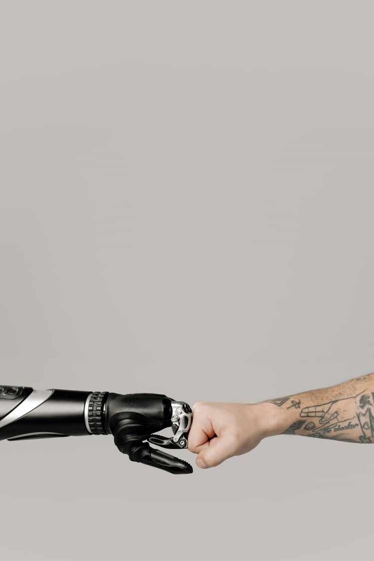 a prosthetic hand and a regular hand fist bumping