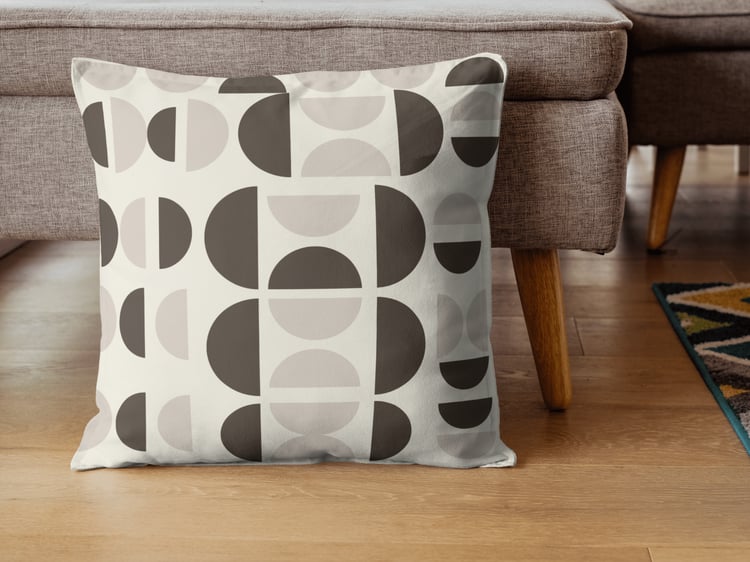 Minimalist neutral throw pillow with mid-century modern geometric semicircle pattern in soft beige tones.
