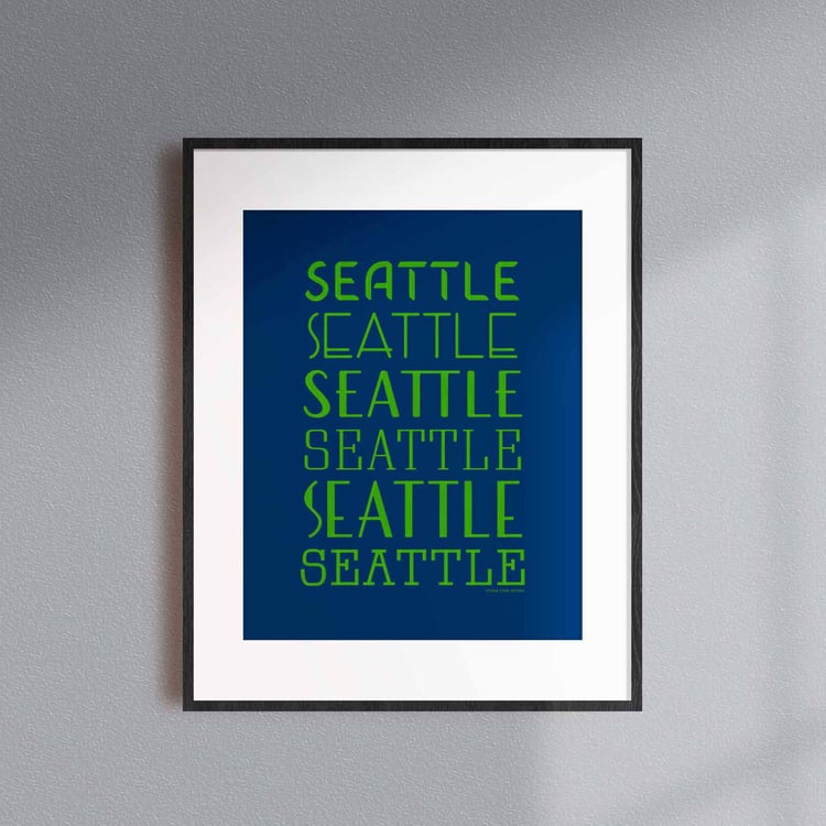 A framed picture of the word "Seattle" drawn in various lettering styles. Artwork has a bright blue and green color scheme