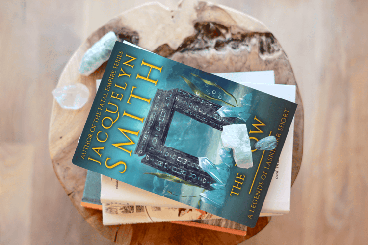 The Vow Legends of Lasniniar paperback on pedestal with crystals