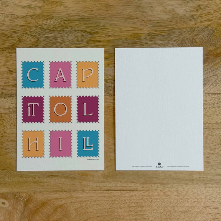 Two sides of a notecard, with postage stamp artwork on the front and a mostly blank back with company contact information at the bottom of the notecard.