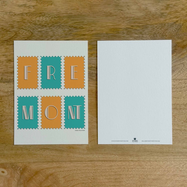 Two sides of a notecard, with postage stamp artwork on the front and a mostly blank back with company contact information at the bottom of the notecard.