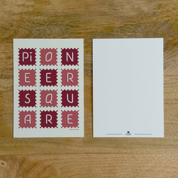 Two sides of a notecard, with postage stamp artwork on the front and a mostly blank back with company contact information at the bottom of the notecard.