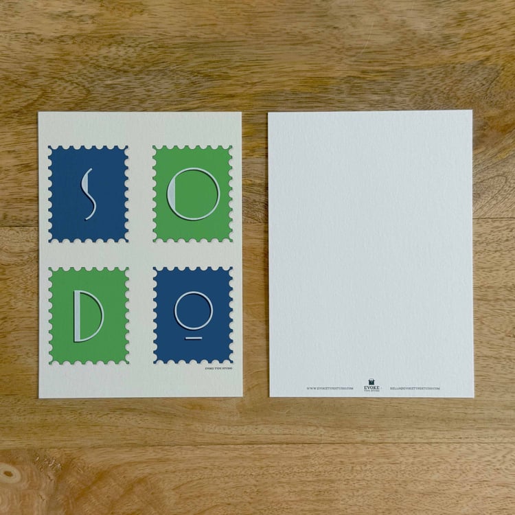 Two sides of a notecard, with postage stamp artwork on the front and a mostly blank back with company contact information at the bottom of the notecard.