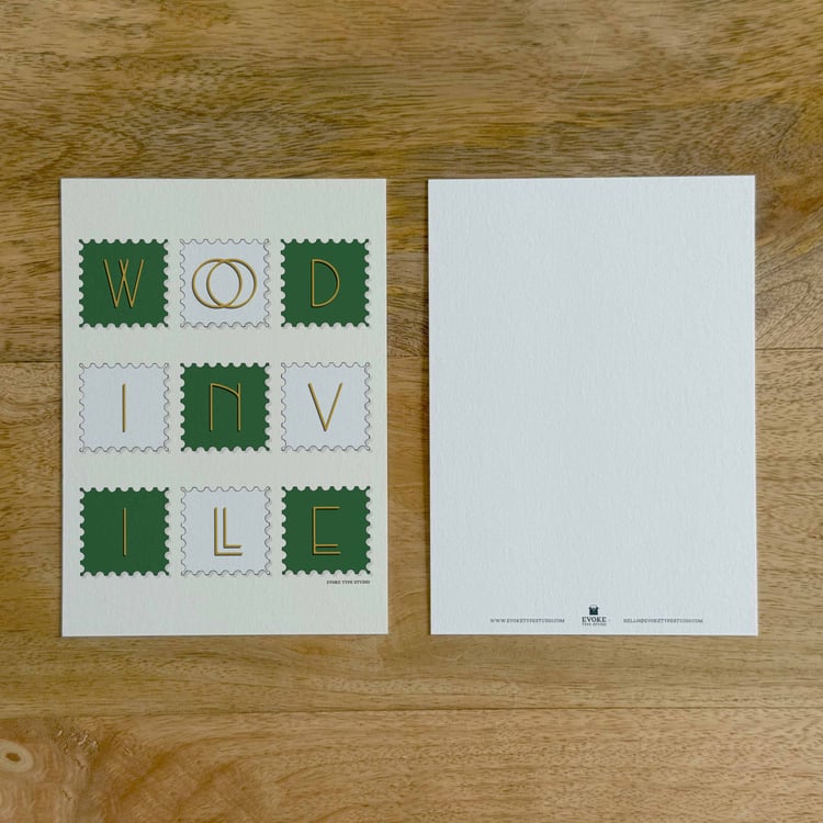 Two sides of a notecard, with postage stamp artwork on the front and a mostly blank back with company contact information at the bottom of the notecard.