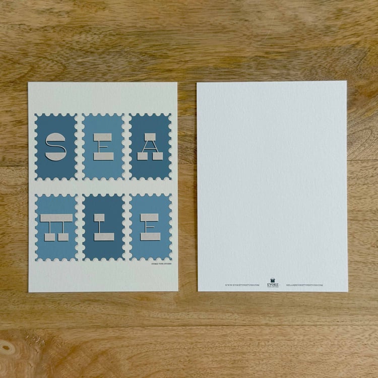 Two sides of a notecard, with postage stamp artwork on the front and a mostly blank back with company contact information at the bottom of the notecard.