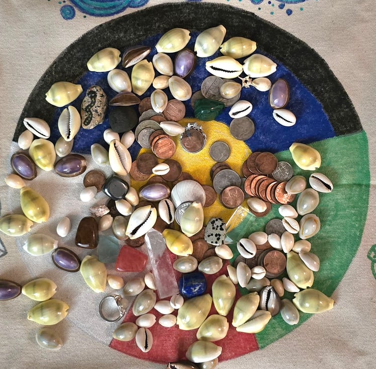 Cowrie shells on a divination mat. Erika smiles in a garden setting.
