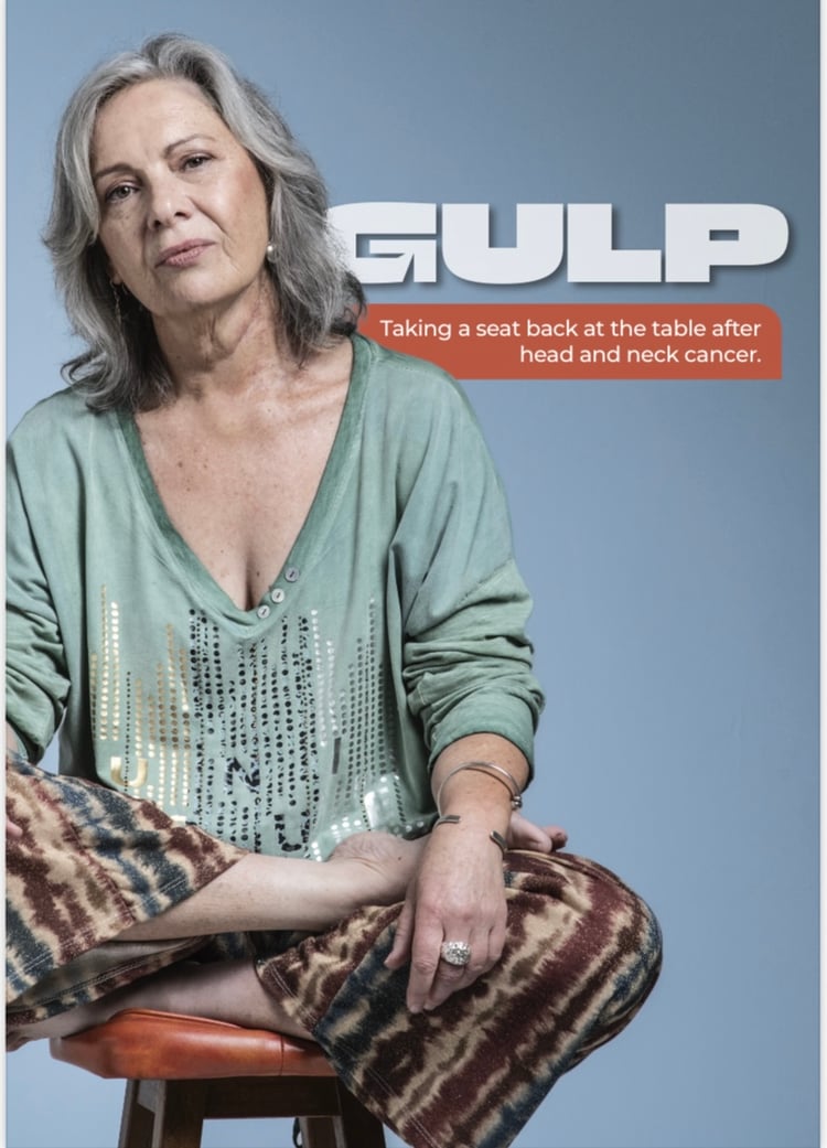 woman sitting on a stool looking directly at camera