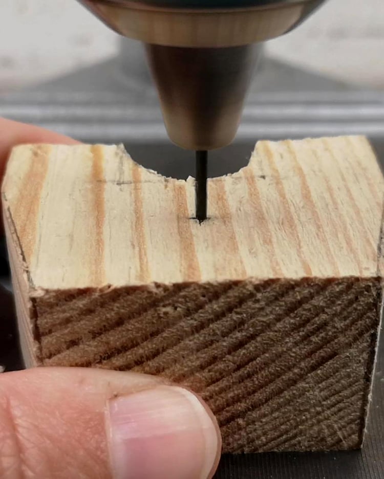 Creating marionette body parts – drilling holes into a wooden puppet chest.