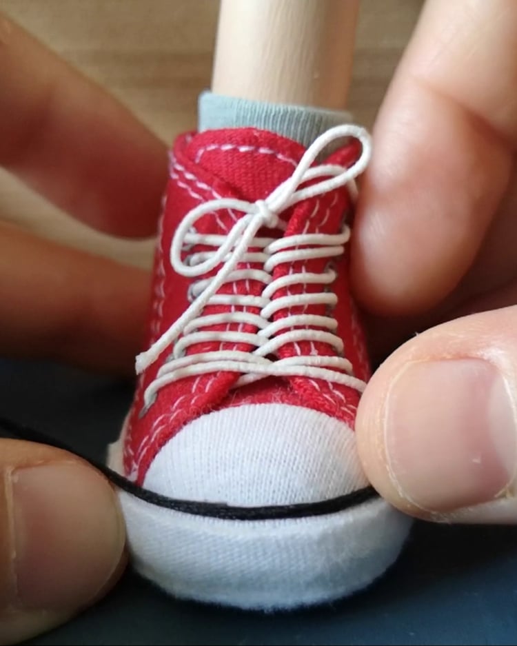 Completed red sneaker for a handmade marionette – DIY puppet shoe crafted with care.