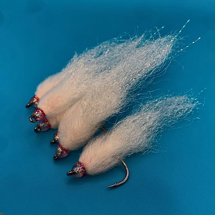 Pile of White & Red Dub Minnow Extended streamers, designed and tied by The Fly Guy, Matt Campbell.