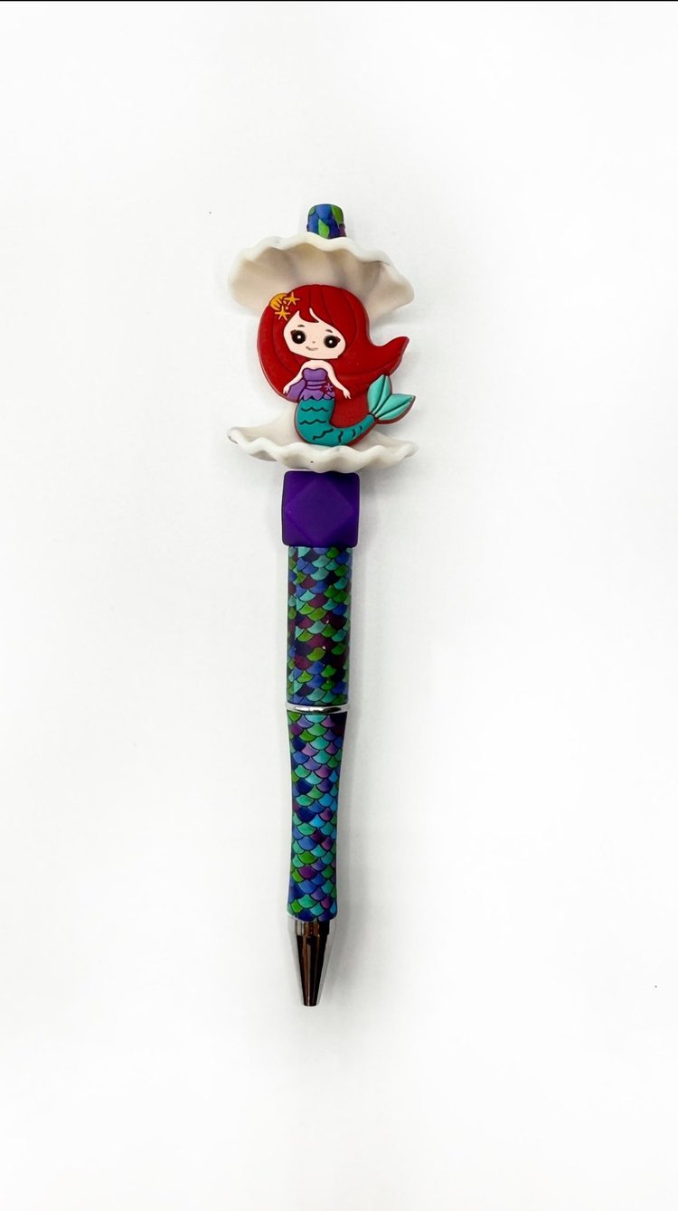 red-haired mermaid figure on top, with a blue and green scaly barrel.