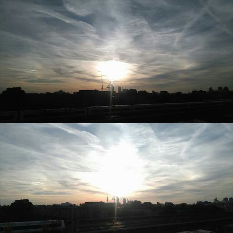 sun bursting through city skyline