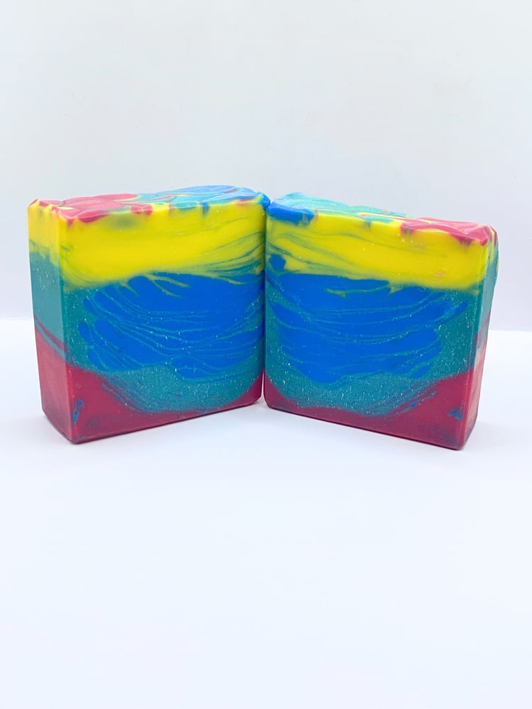 Handmade soap with swirls of yellow, blue, teal, and magenta