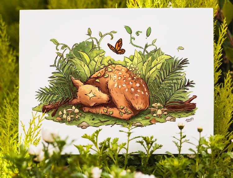 a print of sleeping magical deer surrounded by greenery