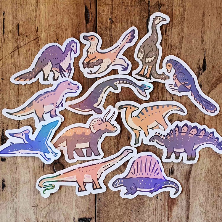 A photo of 12 different stickers. The stickers show dinosaurs and other prehistoric animals.