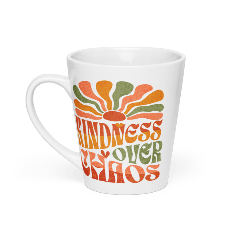 White ceramic latte mug with the phrase “Kindness Over Chaos” in retro groovy typography.