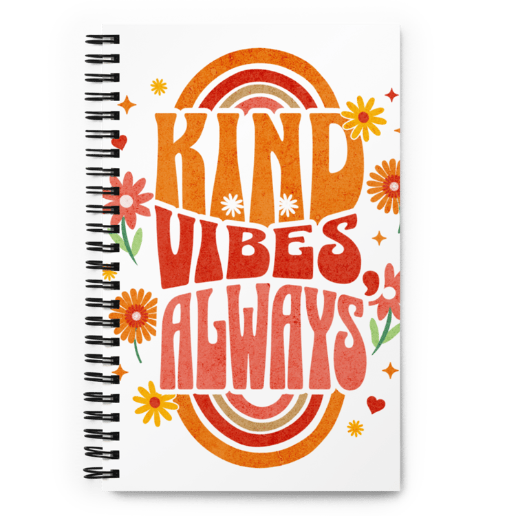 Spiral notebook with retro lettering on the cover that reads “Kind Vibes, Always.”