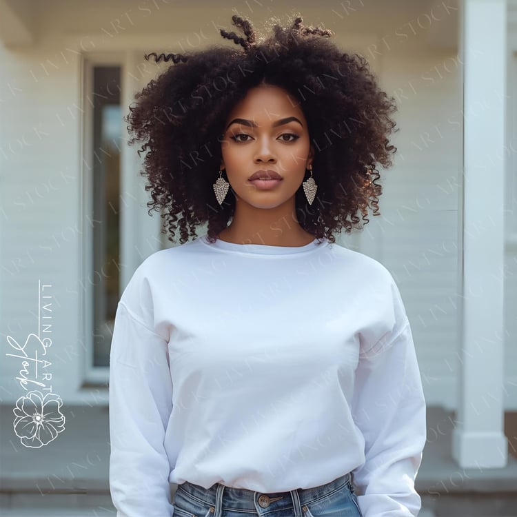 A bold, centered, medium close-up portrait captures a stunning young Black woman with impressive natural afro-textured hair and a serious, direct gaze toward the camera, conveying confidence and strength. She is wearing a plain, oversized white crewneck s
