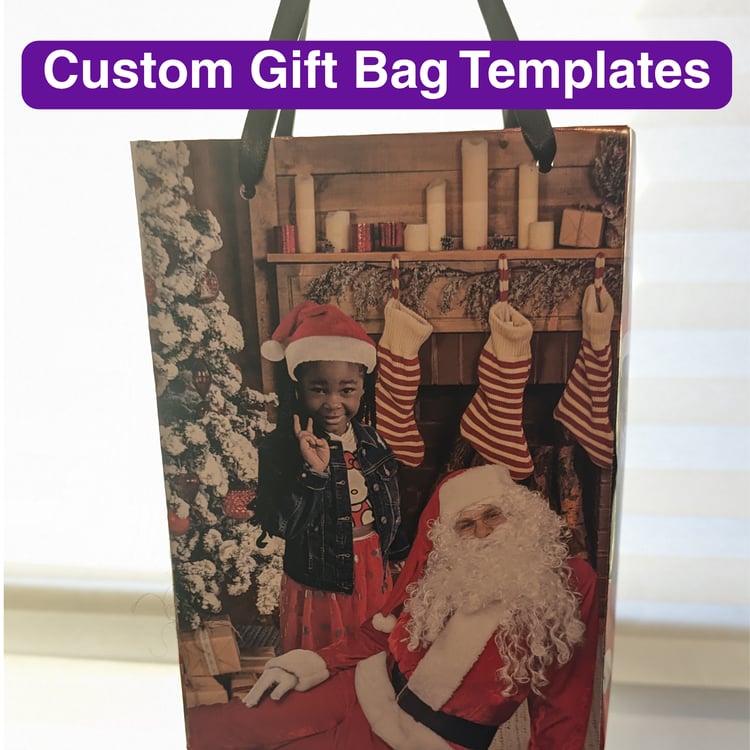 Gift bag with image of a little girl with Santa next to a Christmas tree by a fireplace with stockings hanging