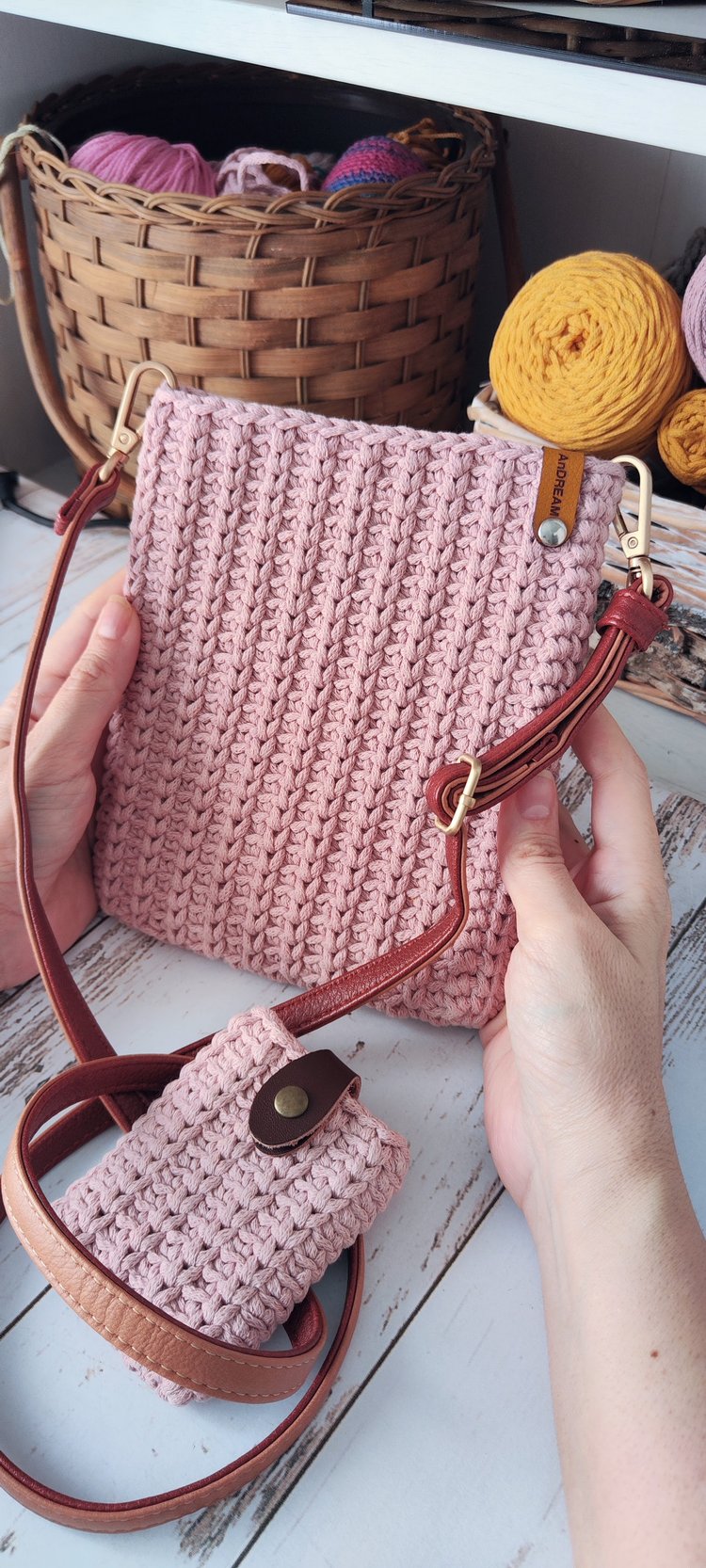 Minimalist crochet crossbody bag made with cotton rope yarn, side view showing knit-purl texture and leather strap