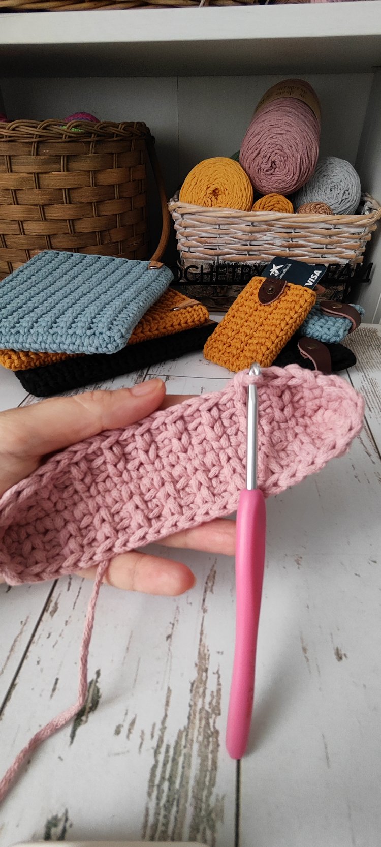 Dusty rose coloured crossbody bag in cotton rope yarn, simple leather tag branding ‘AnDREAM Crochet’ visible, elegant accessory