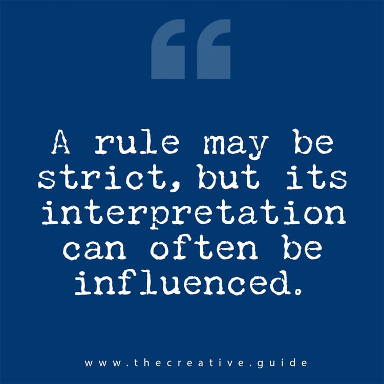 A bold typographic quote appears against a deep blue background, centered on the square canvas. The text reads, “A rule may be strict, but its interpretation can often be influenced.” The font mimics a typewriter, giving it a tactile, slightly uneven feel that echoes the human tone of The Creative Guide’s “Monday Reset.” Above the quote, a pair of large quotation marks are faintly visible. Below, the website address sits small and centered in lowercase white text.