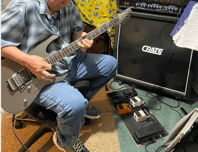 Person working on guitar technique.