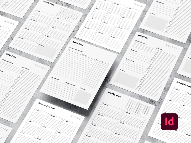 Mockup of different minimalist planner sheets (black and white) on a marble surface, with an InDesign icon in the bottom right corner.