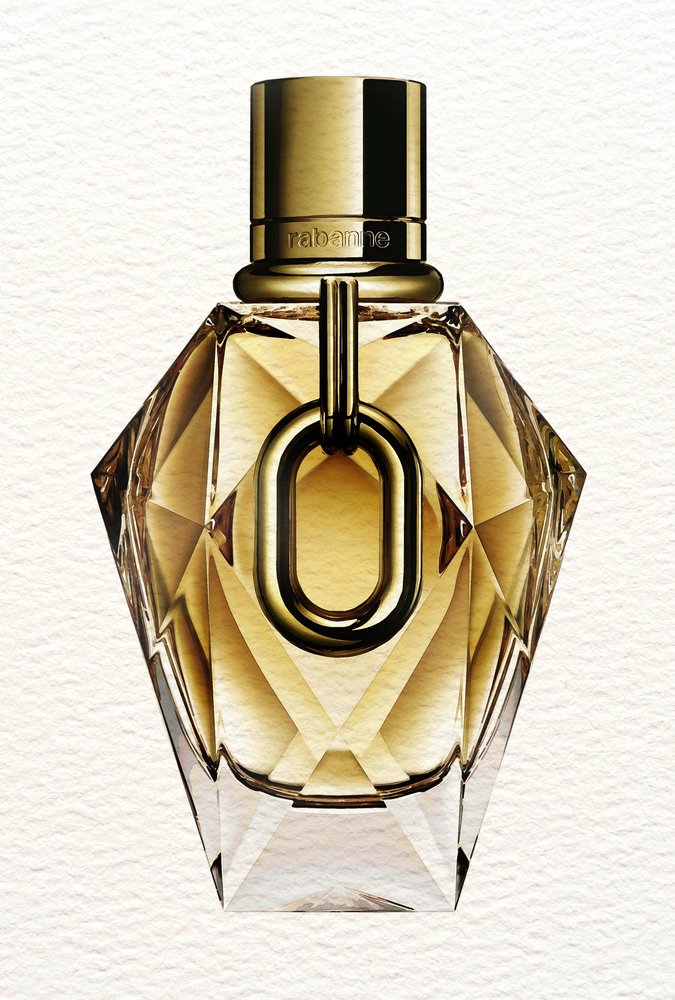 A watercolor digital art portrait that showcases Rabanne's Million Gold for Here fragrance set against a cream-colored textured background