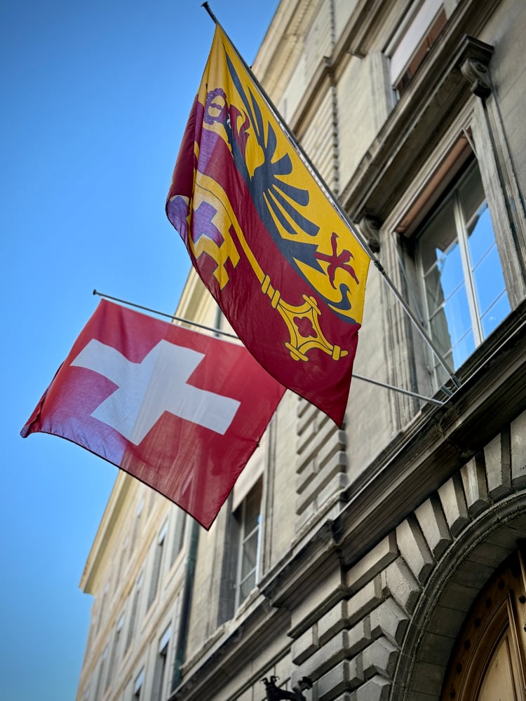 Swiss and Geneva flags on a building in Geneva Old Town, Switzerland