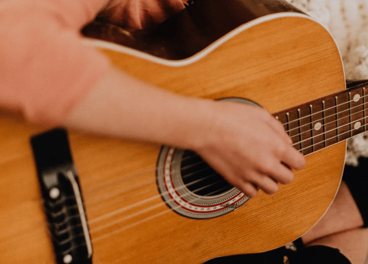 Strumming the acoustic guitar