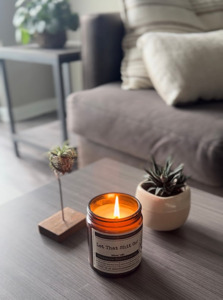 calming image of candle and plants in warm lighting