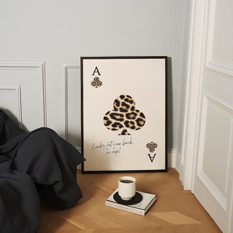 Leopard print playing card wall art poster with quote typography, framed minimalist artwork styled in a modern interior.