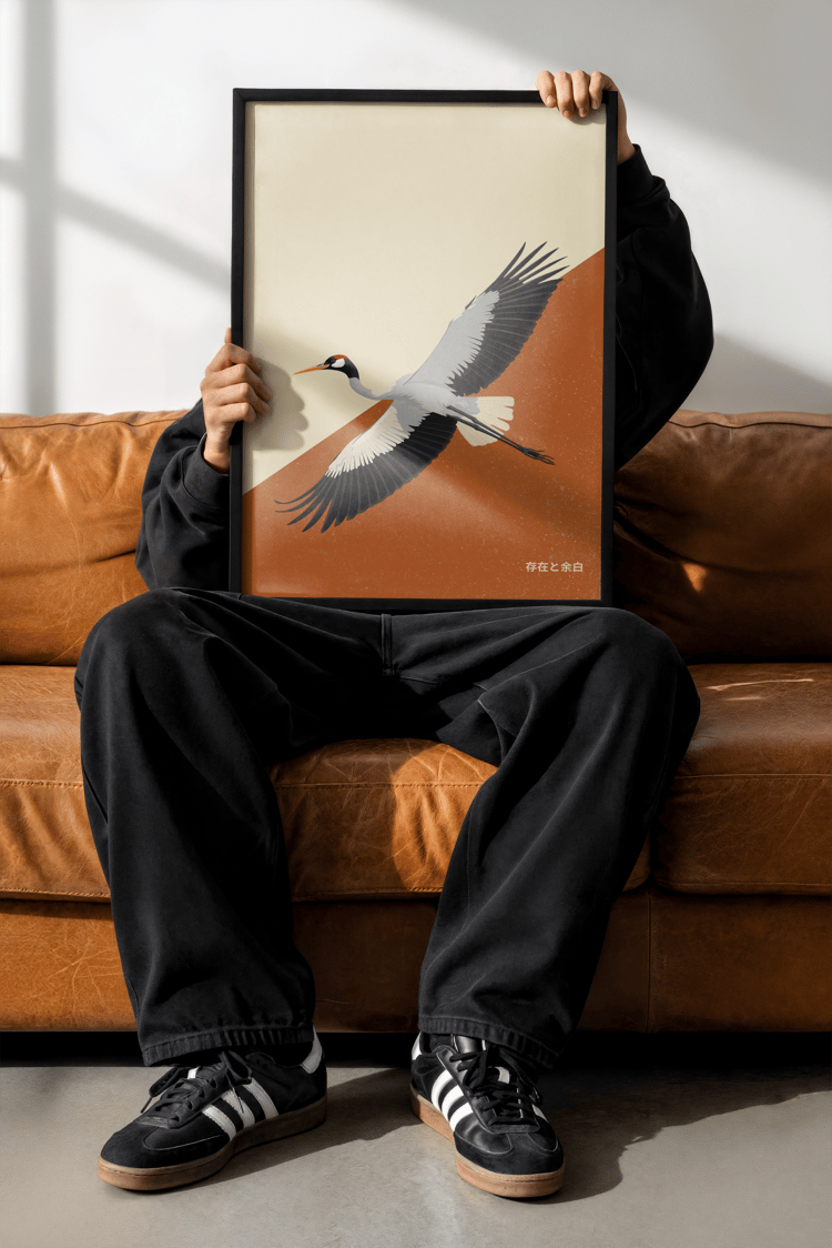 Minimalist Japanese crane wall art poster with flying crane illustration in neutral tones, framed artwork displayed in a modern interior.