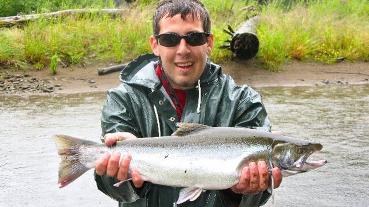 Fly fishing guide Matt Campbell with a large Dolly Varden caught in Southeast Alaska on a Flesh Wound streamer.