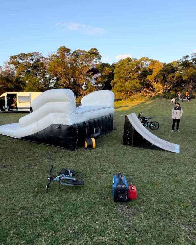 Commercial-grade black inflatable air bag landing pad measuring 20x13x5ft with reinforced seams and 0.6mm PVC construction for MTB and BMX training.