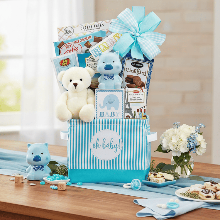 Gift basket for a baby with toys and snacks on a wooden surface.