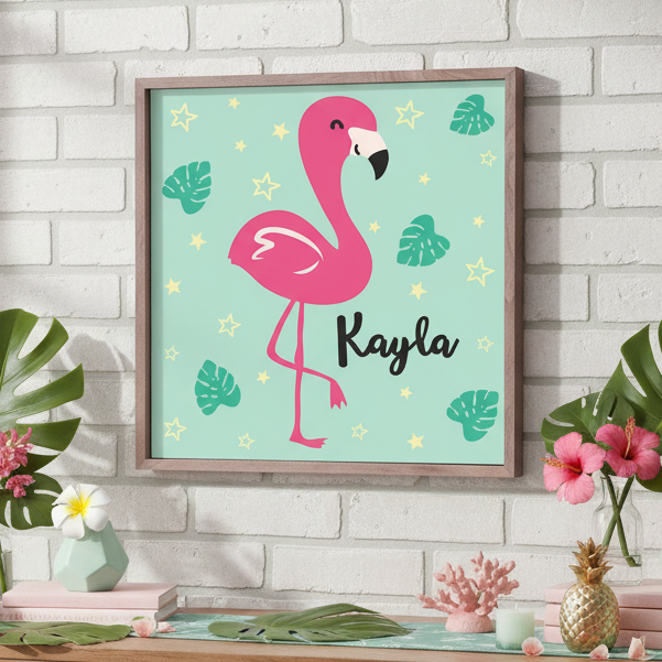 Framed artwork with a pink flamingo design on a wall above a wooden table.